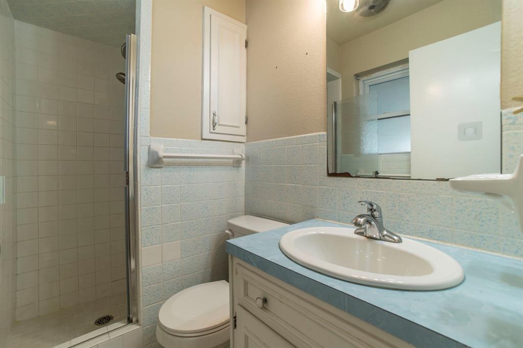 705 South 4th Street Midlothian, TX 76065 - Photo 9 of 15 a bathroom with a sink a toilet and a mirror