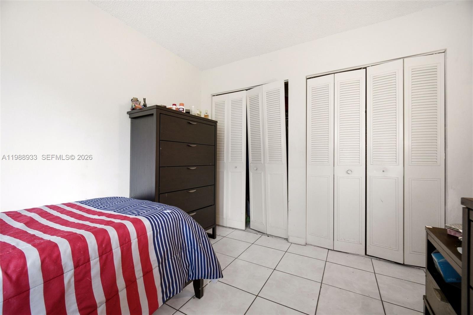 841 Southwest 55th Avenue Margate, FL 33068 - Photo 24 of 26 a bedroom with a bed and cabinets