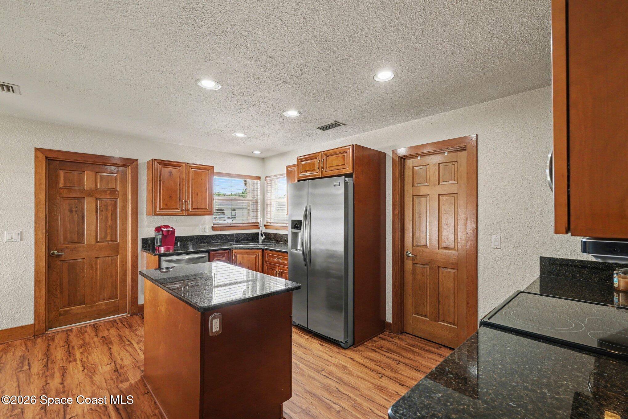 2604 Senator Way Melbourne, FL 32901 - Photo 11 of 27 a kitchen with stainless steel appliances granite countertop a refrigerator a sink and a stove