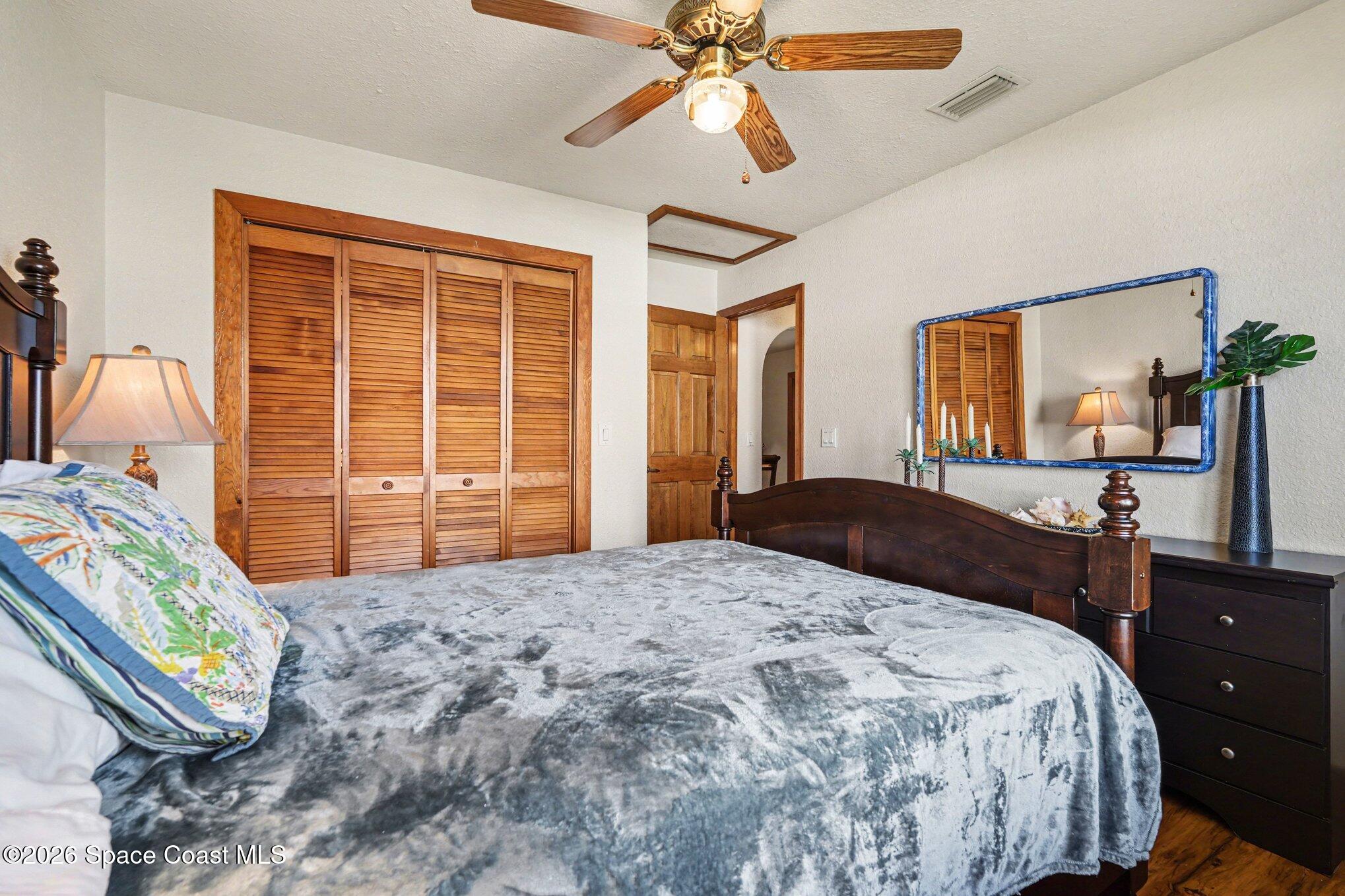 2604 Senator Way Melbourne, FL 32901 - Photo 13 of 27 a bedroom with a bed dresser and a window