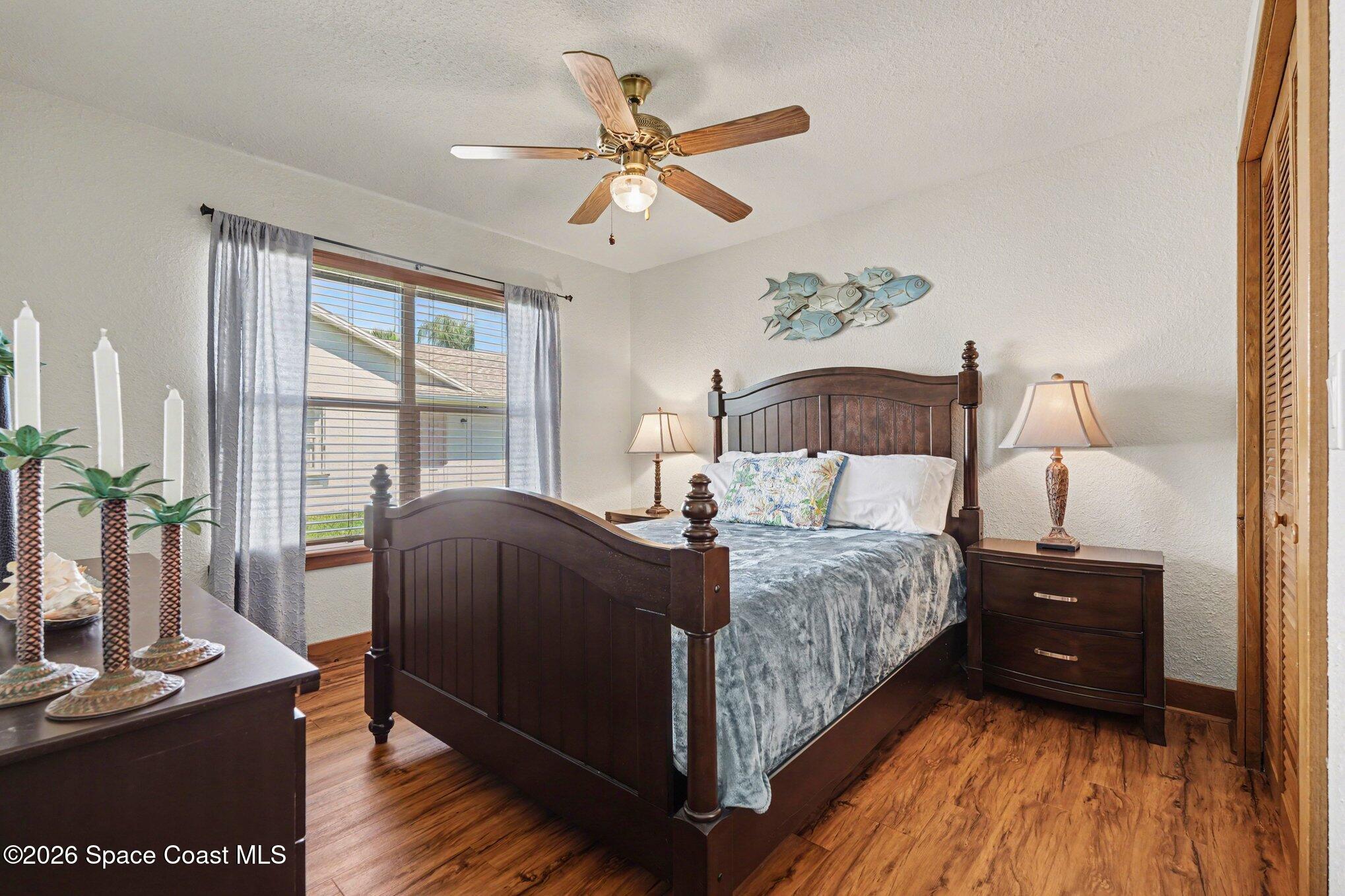 2604 Senator Way Melbourne, FL 32901 - Photo 15 of 27 a bedroom with a bed and wooden floor