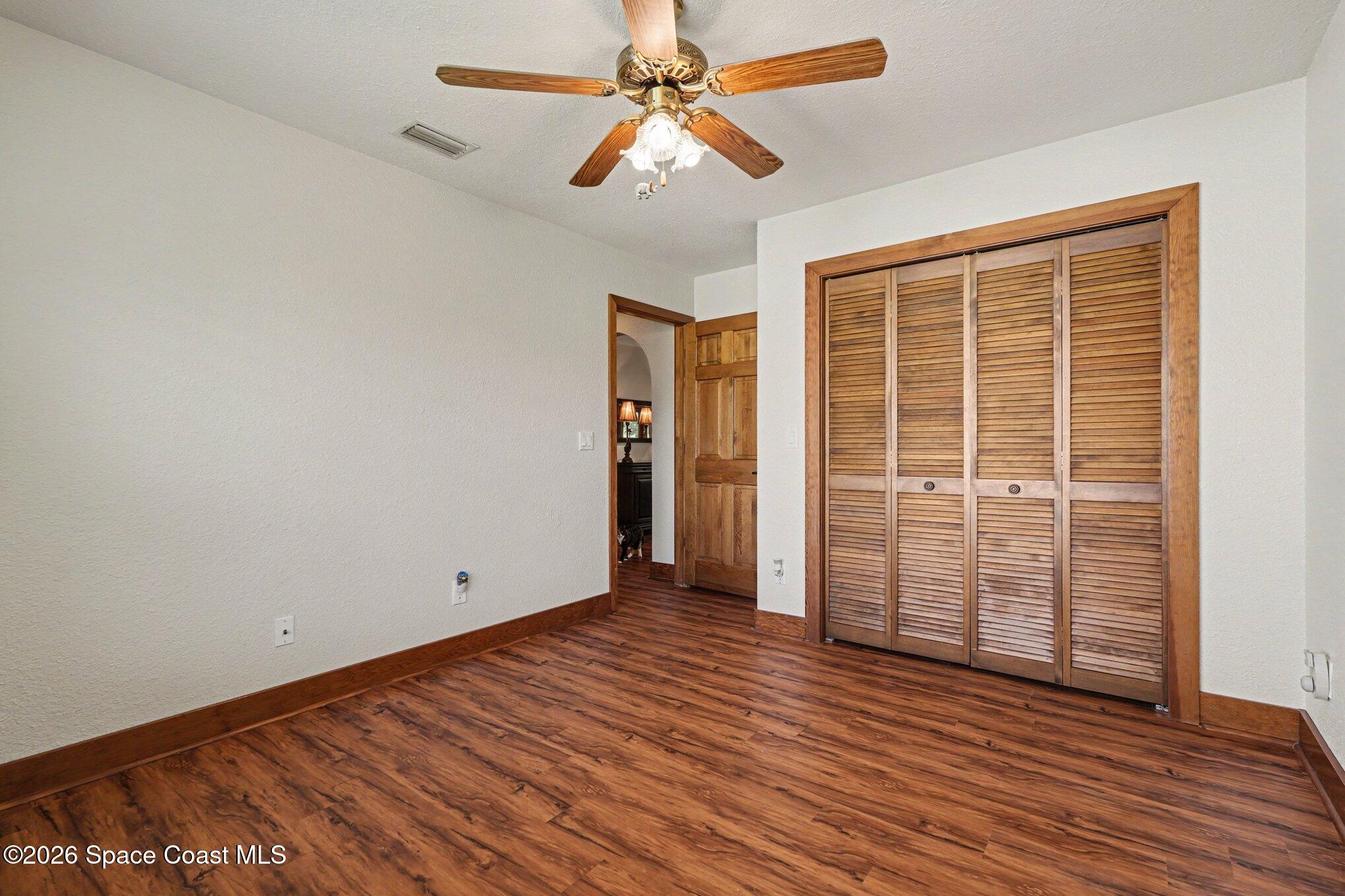 2604 Senator Way Melbourne, FL 32901 - Photo 16 of 27 an empty room with wooden floor and windows