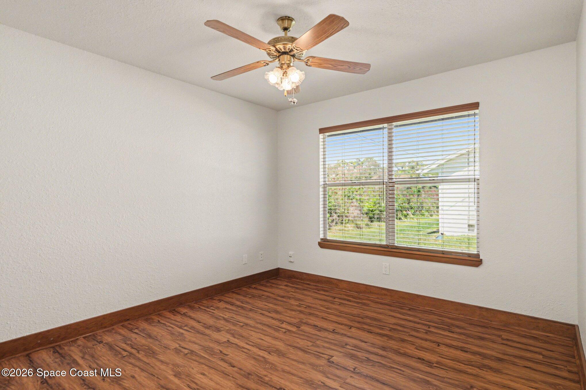 2604 Senator Way Melbourne, FL 32901 - Photo 17 of 27 an empty room with wooden floor and windows