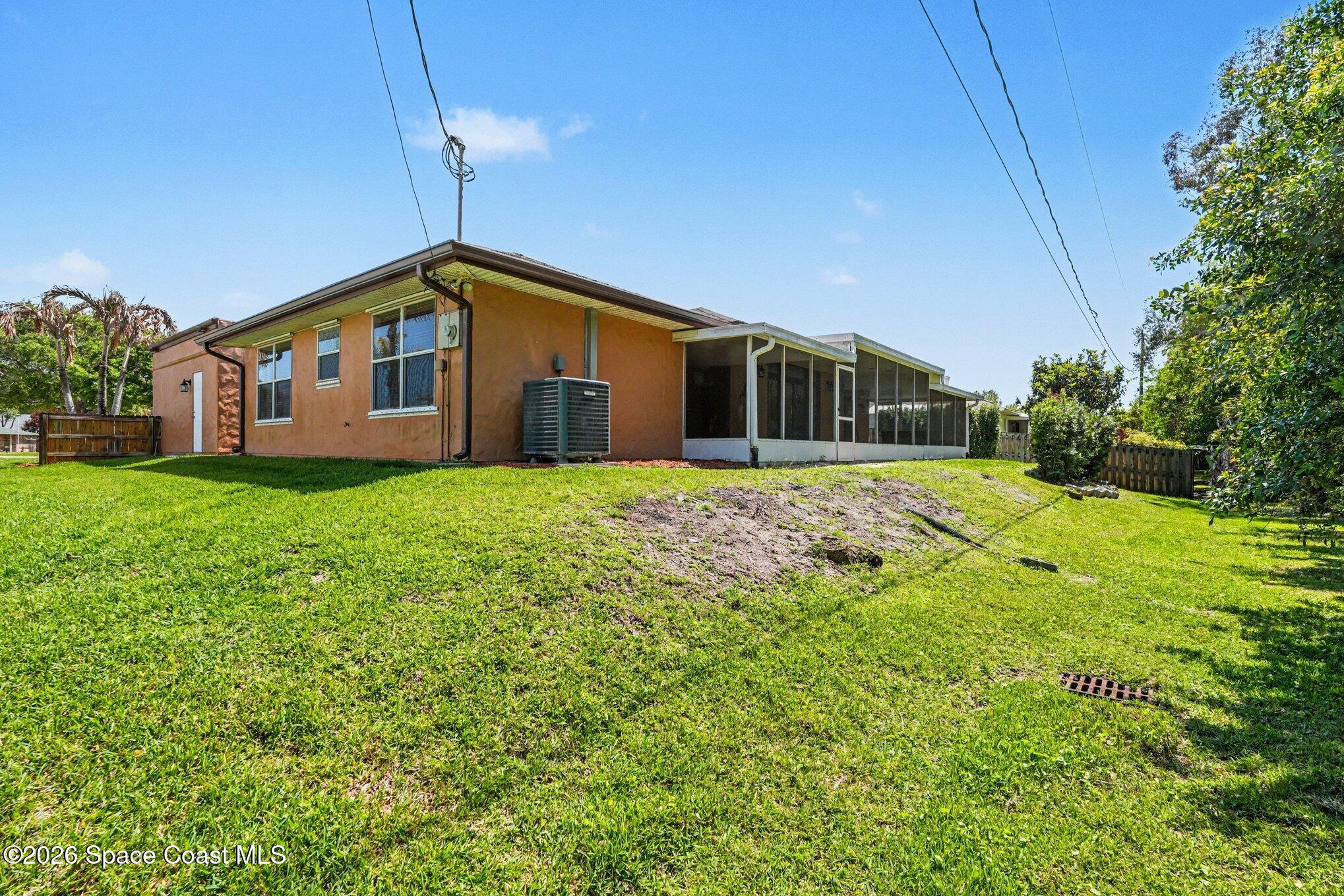 2604 Senator Way Melbourne, FL 32901 - Photo 25 of 27 a front view of house with yard and green space