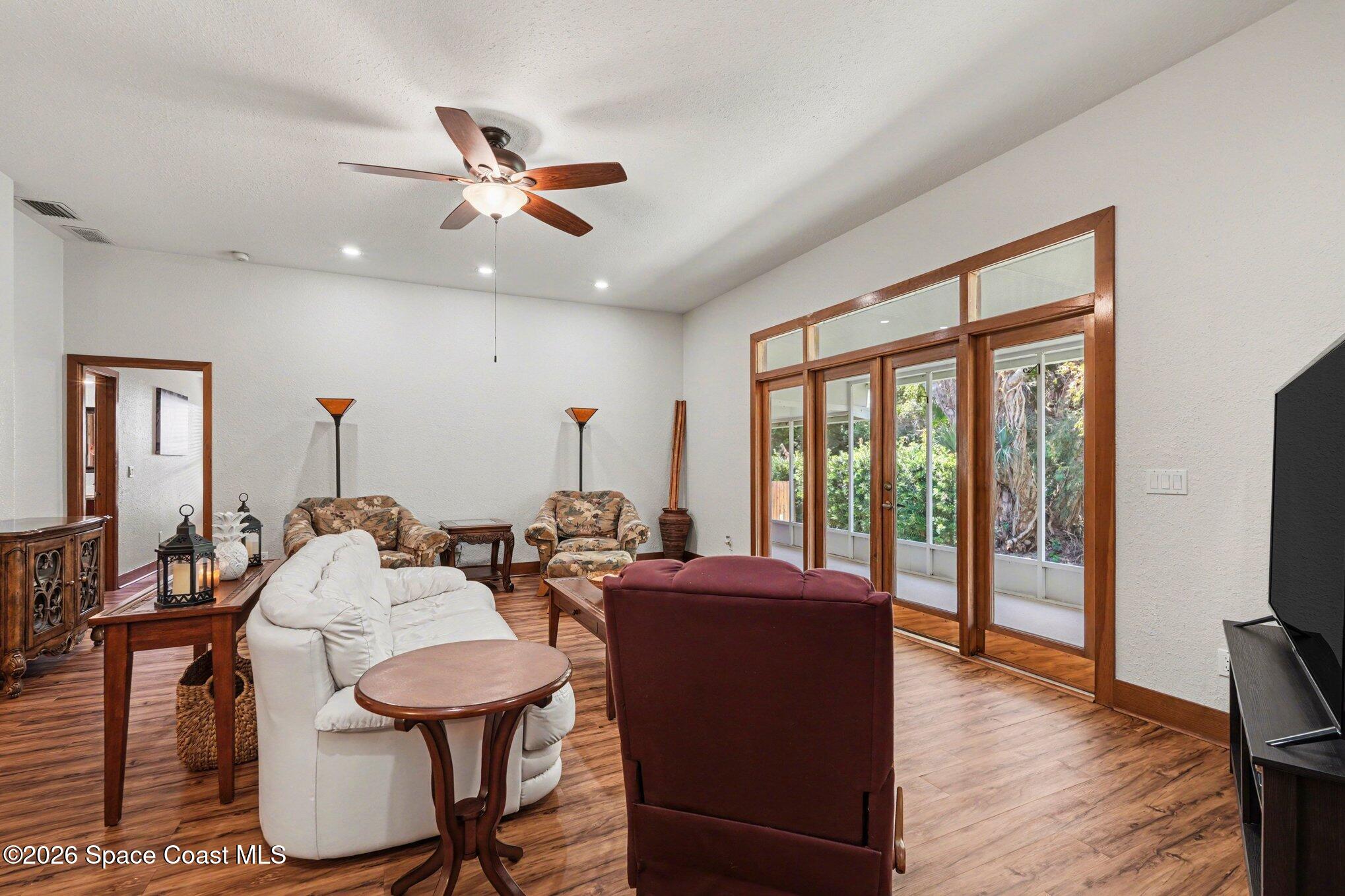 2604 Senator Way Melbourne, FL 32901 - Photo 6 of 27 a living room with furniture a ceiling fan and a large window