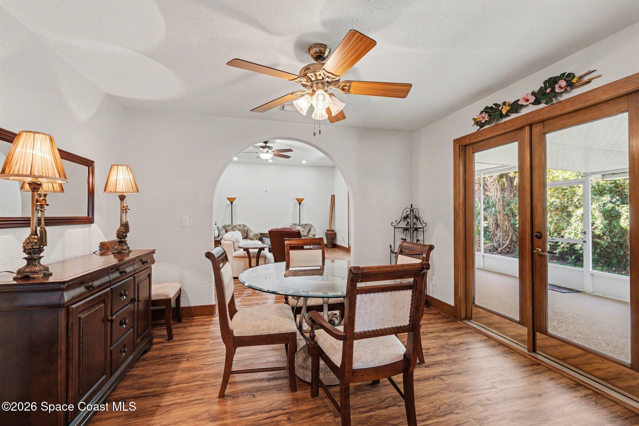 2604 Senator Way Melbourne, FL 32901 - Photo 8 of 27 a dining room with furniture a chandelier and wooden floor