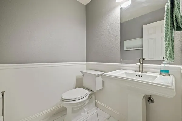 a spacious bathroom with a double vanity sink a mirror and a bathtub