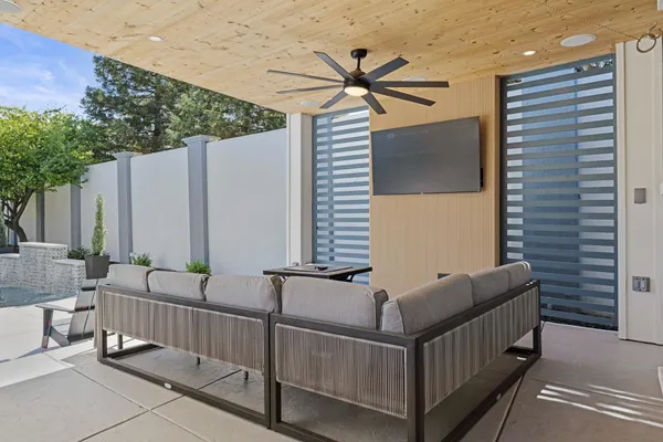 a backyard of a house with table and chairs