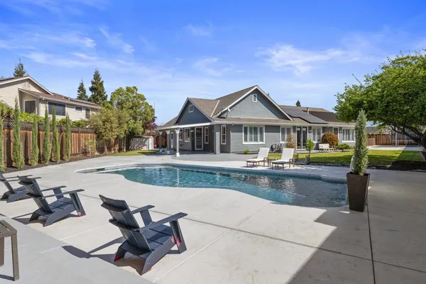 a house with swimming pool in front of it
