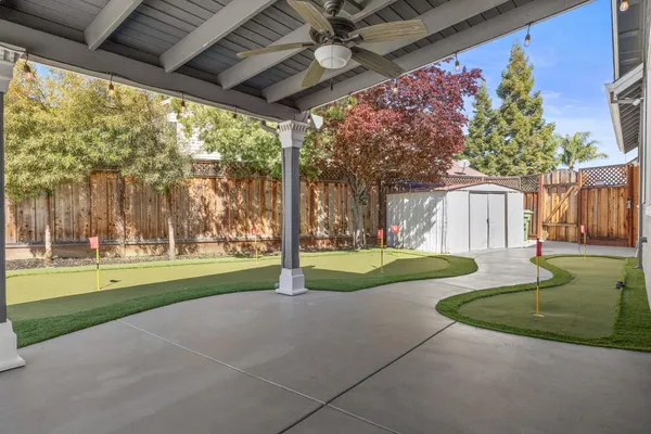 a view of a hallway with wooden floor and dining room