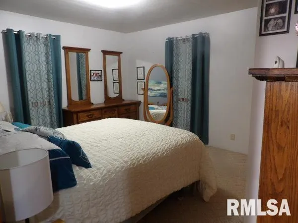 a bedroom with a bed and a desk