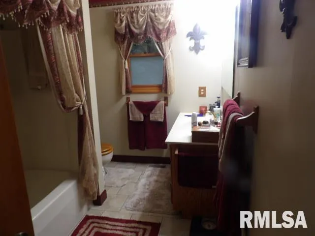 a bathroom with a sink vanity and a mirror