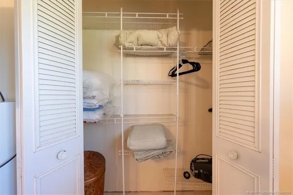 a spacious bedroom with a bed and a flat screen tv