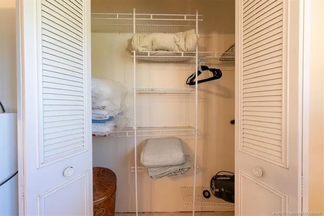 a spacious bedroom with a bed and a flat screen tv