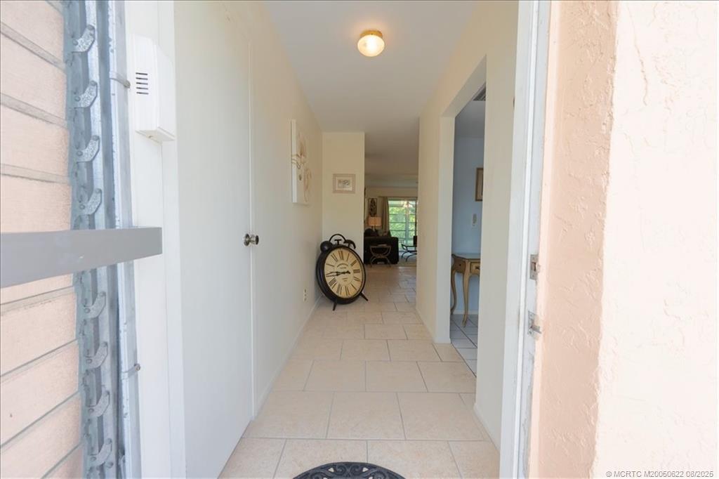 2950 Southeast Ocean Boulevard, Unit 556 Stuart, FL 34996 - Photo 20 of 33 a white house with glass door and glass door