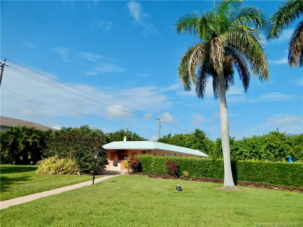 a view of a backyard with a garden and entertaining space