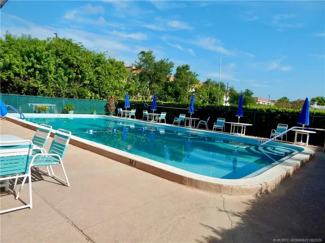 swimming pool view with a seating space