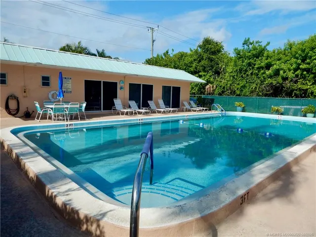 a view of a stadium that has a small yard and a large trees