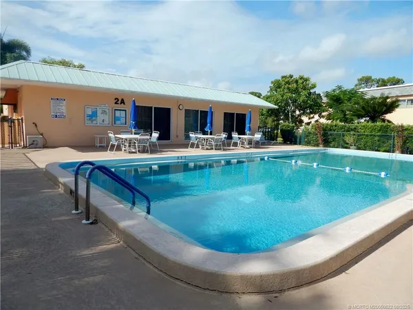 a view of a swimming pool with a outdoor seating