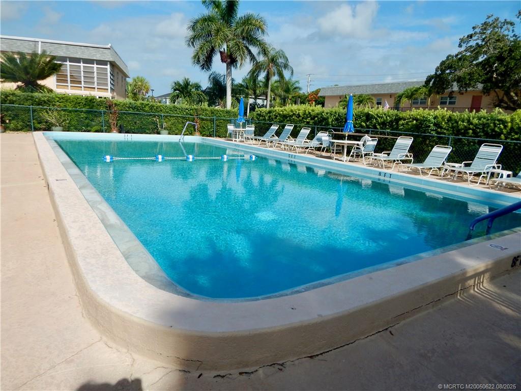 2950 Southeast Ocean Boulevard, Unit 556 Stuart, FL 34996 - Photo 31 of 33 a view of a swimming pool with a outdoor seating