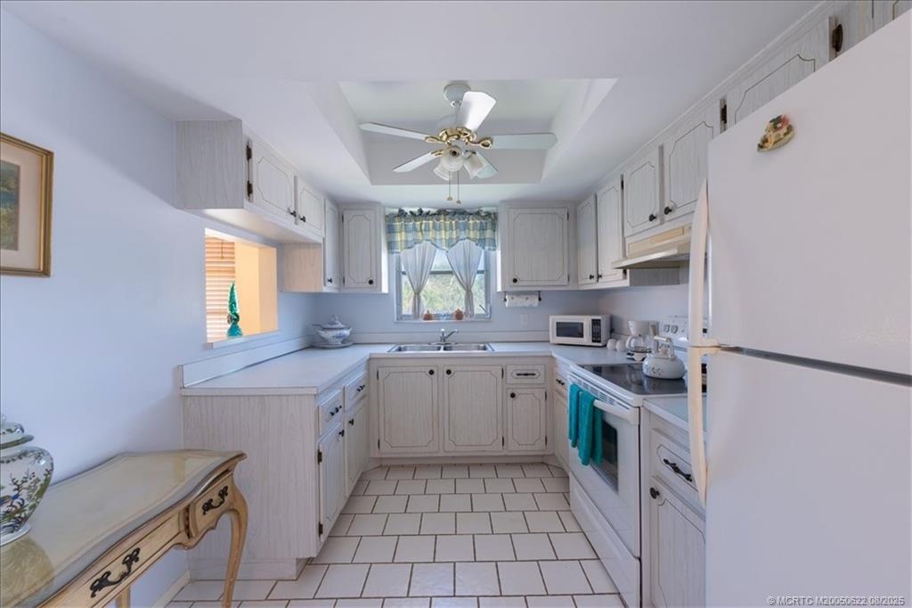 2950 Southeast Ocean Boulevard, Unit 556 Stuart, FL 34996 - Photo 4 of 33 a kitchen with a sink cabinets stainless steel appliances and a window