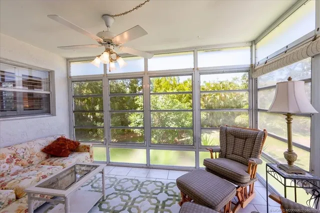 a living room with furniture a chandelier and a dining table