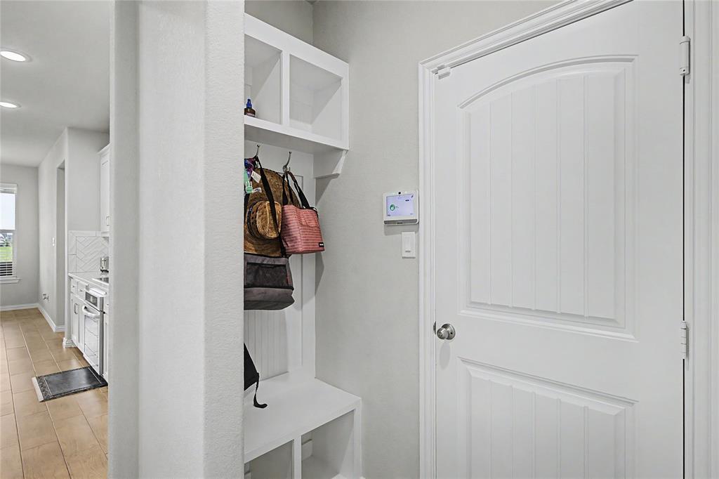 185 Chester Road Springtown, TX 76082 - Photo 34 of 40 Built-in mudroom bench with cubbies, upper shelving, and coat hooks