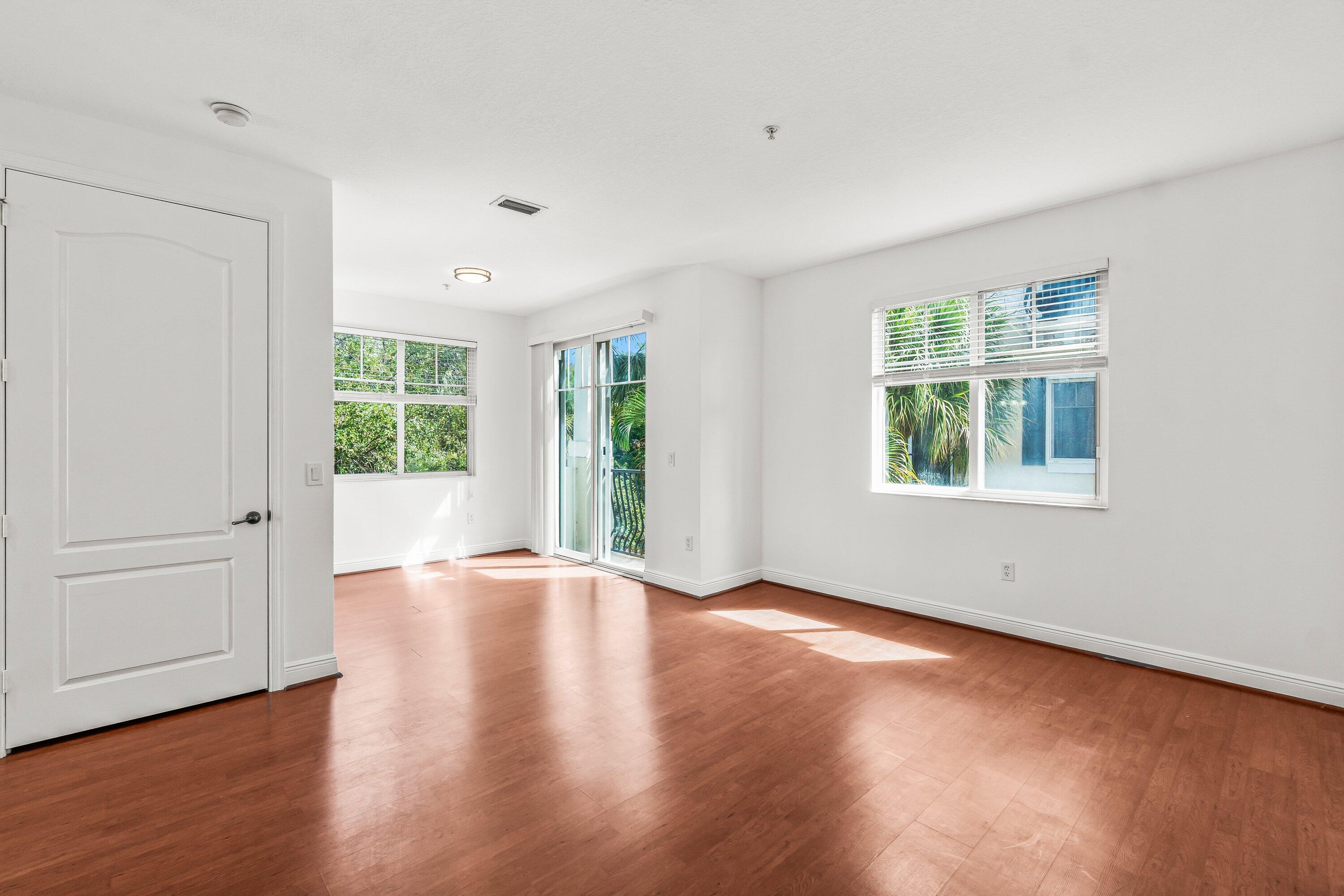 3830 Northwest 5th Terrace Boca Raton, FL 33431 - Photo 17 of 30 an empty room with wooden floor and windows