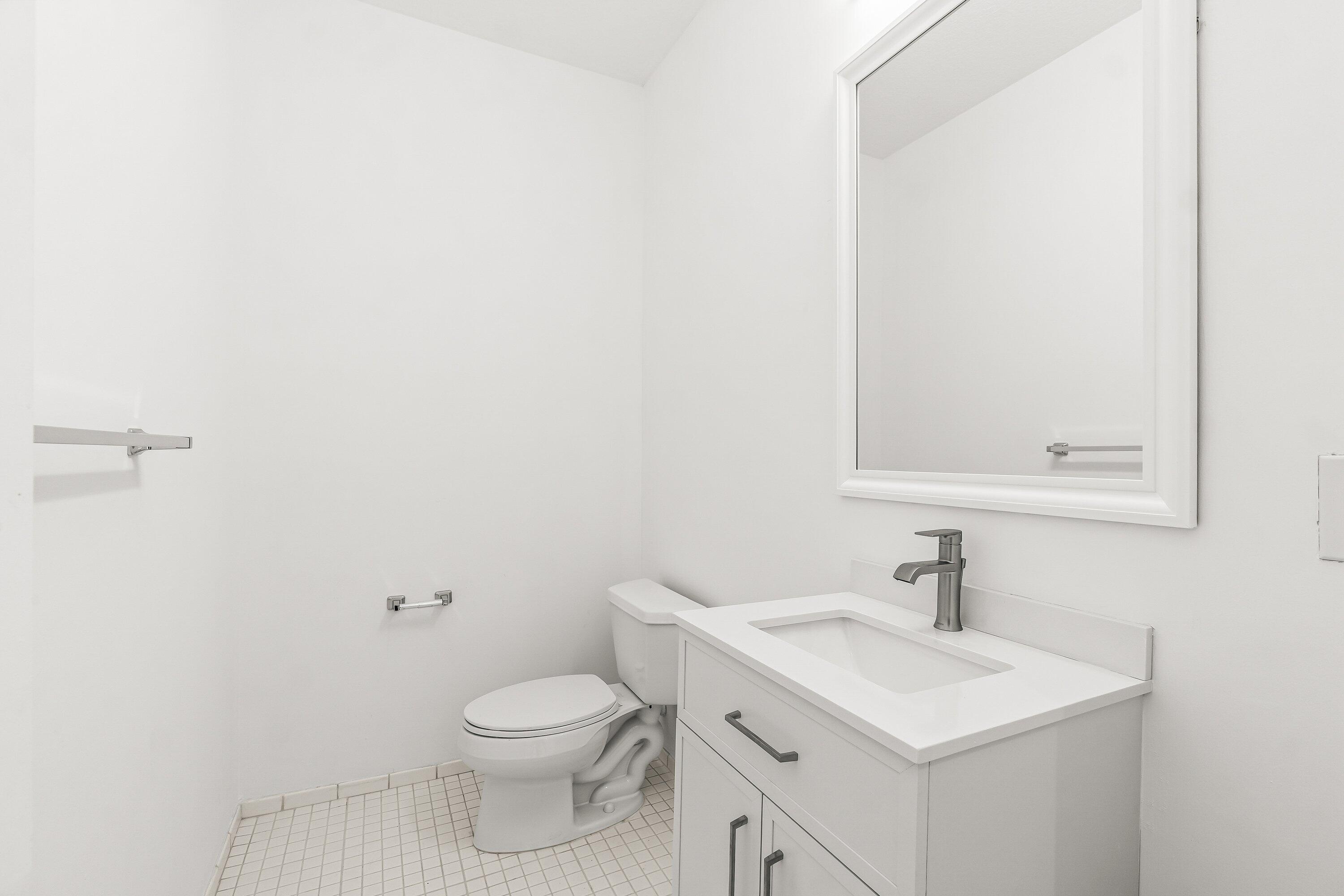 3830 Northwest 5th Terrace Boca Raton, FL 33431 - Photo 19 of 30 a bathroom with a toilet a sink and mirror