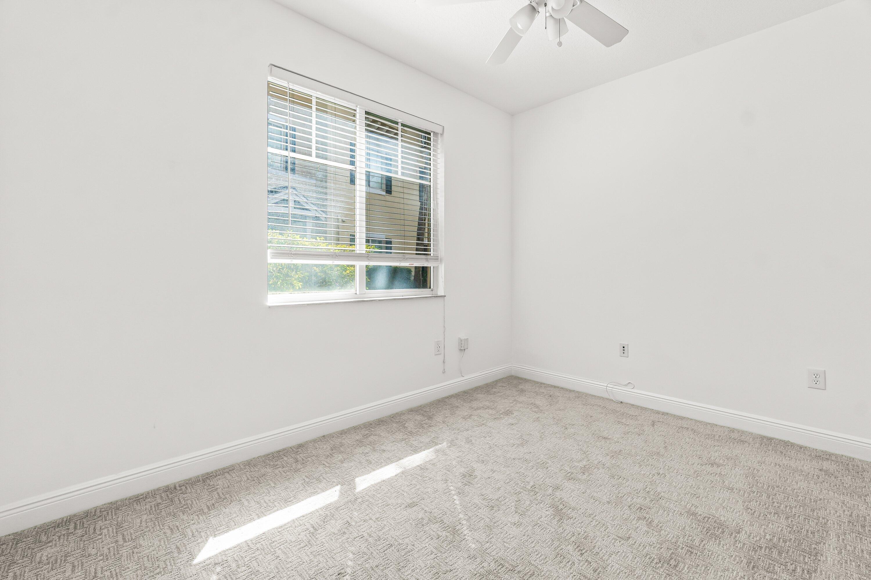 3830 Northwest 5th Terrace Boca Raton, FL 33431 - Photo 6 of 30 an empty room with a window and a chandelier fan