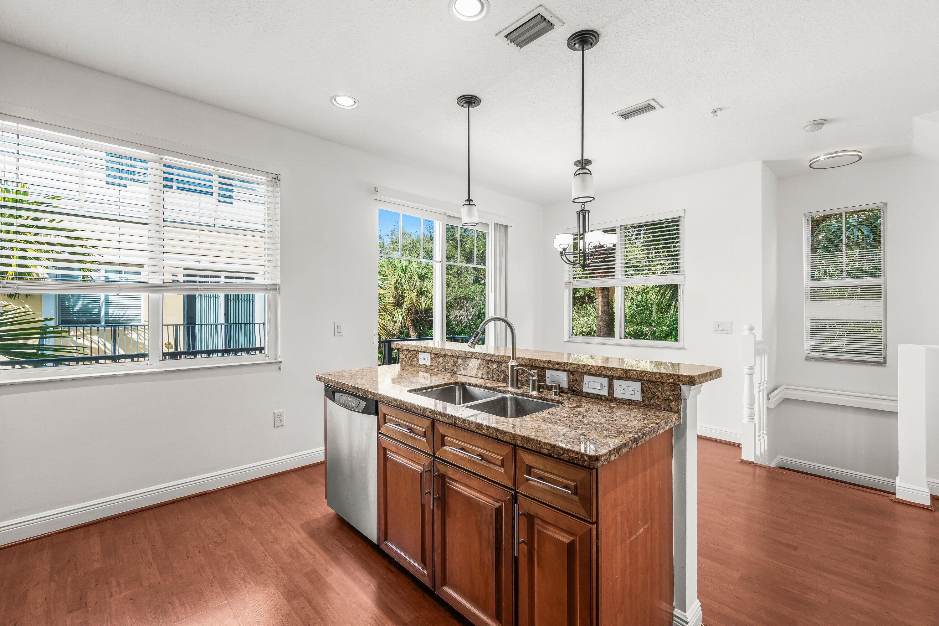 3830 Northwest 5th Terrace Boca Raton, FL 33431 - Photo 10 of 30 a kitchen that has a sink a window and cabinets