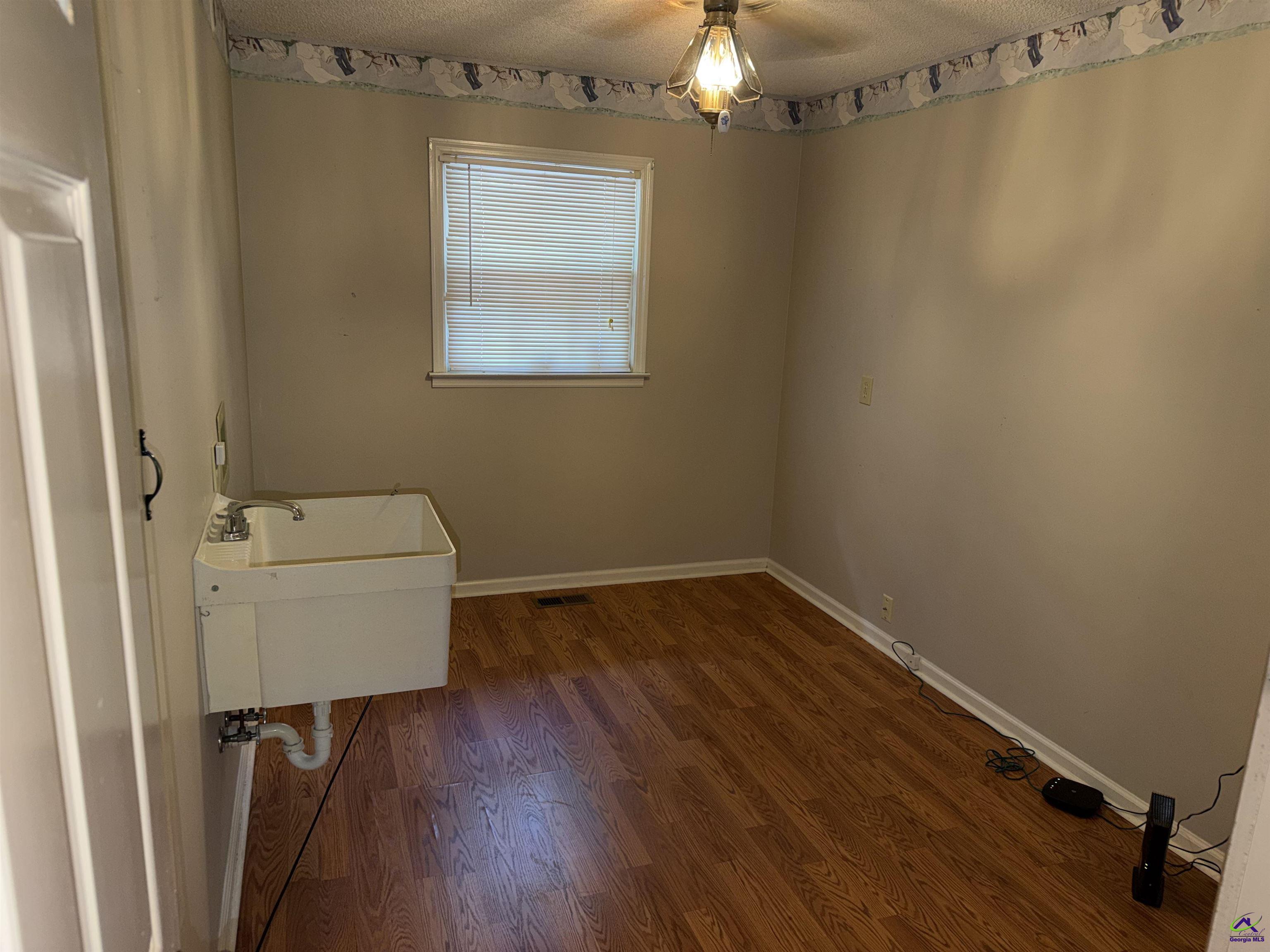249 Hatcher Road Warner Robins, GA 31088 - Photo 14 of 25 a view of a room with wooden floor and a window