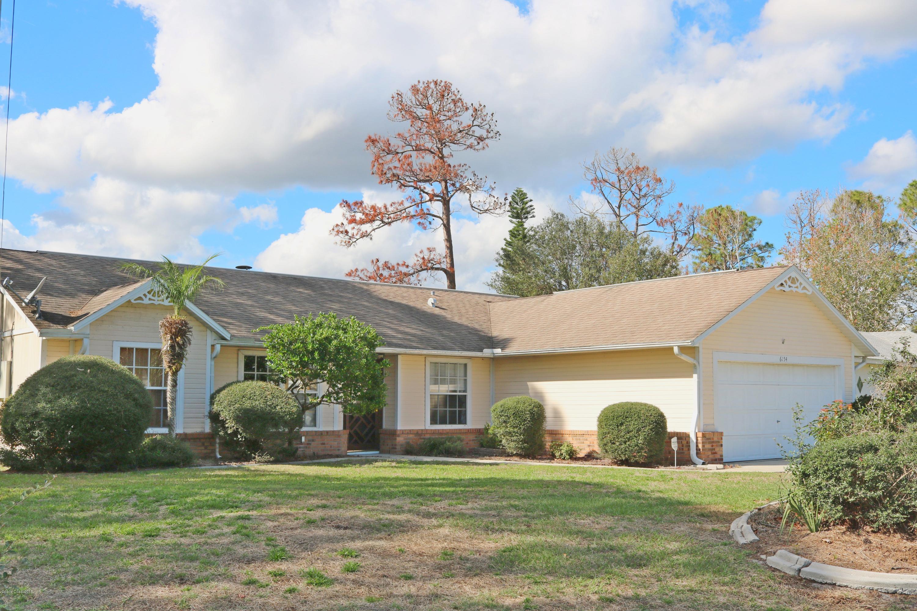 6154 Corning Road Cocoa, FL 32927 - Photo 1 of 16 a front view of a house with a garden