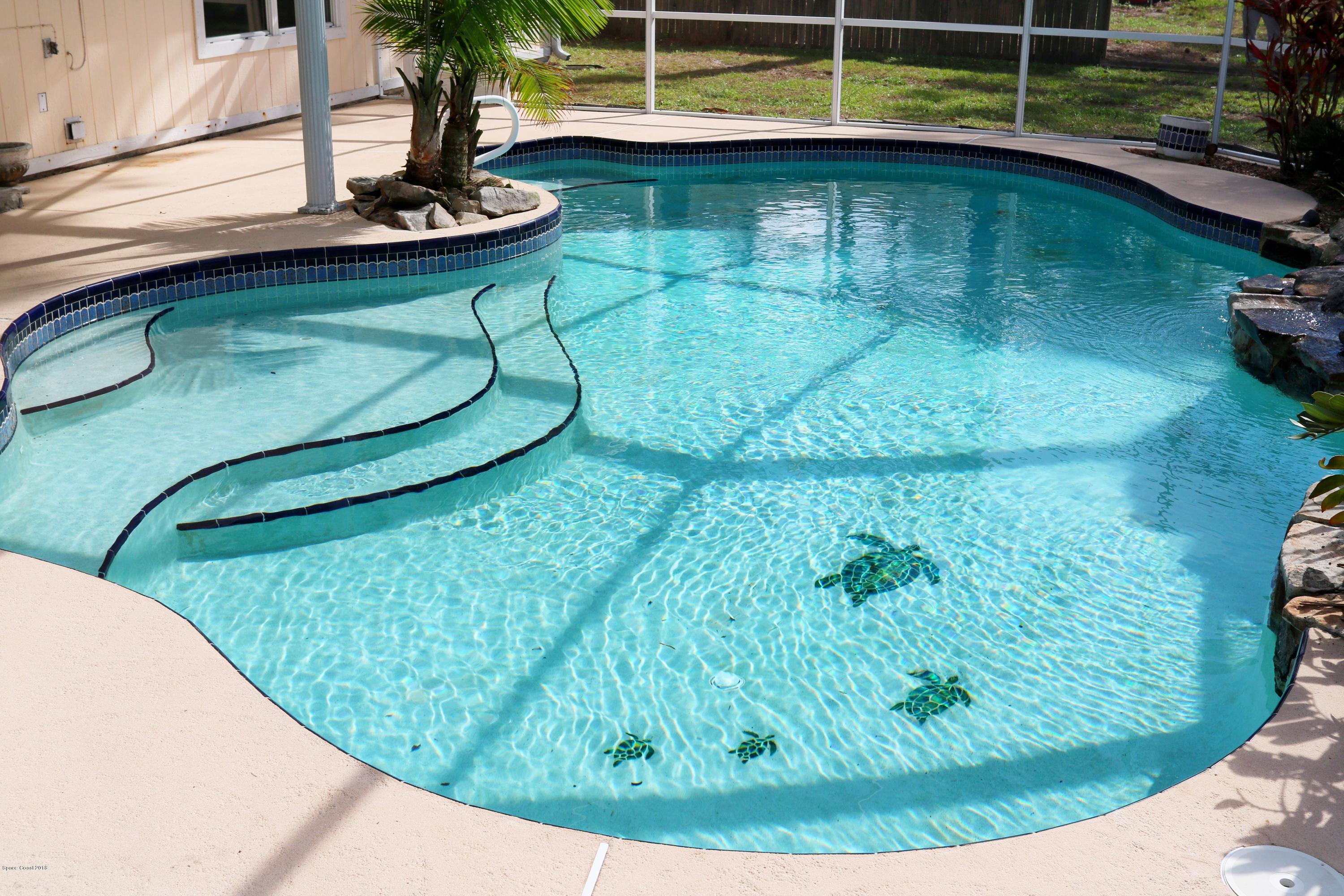 6154 Corning Road Cocoa, FL 32927 - Photo 13 of 16 a view of a swimming pool with a yard