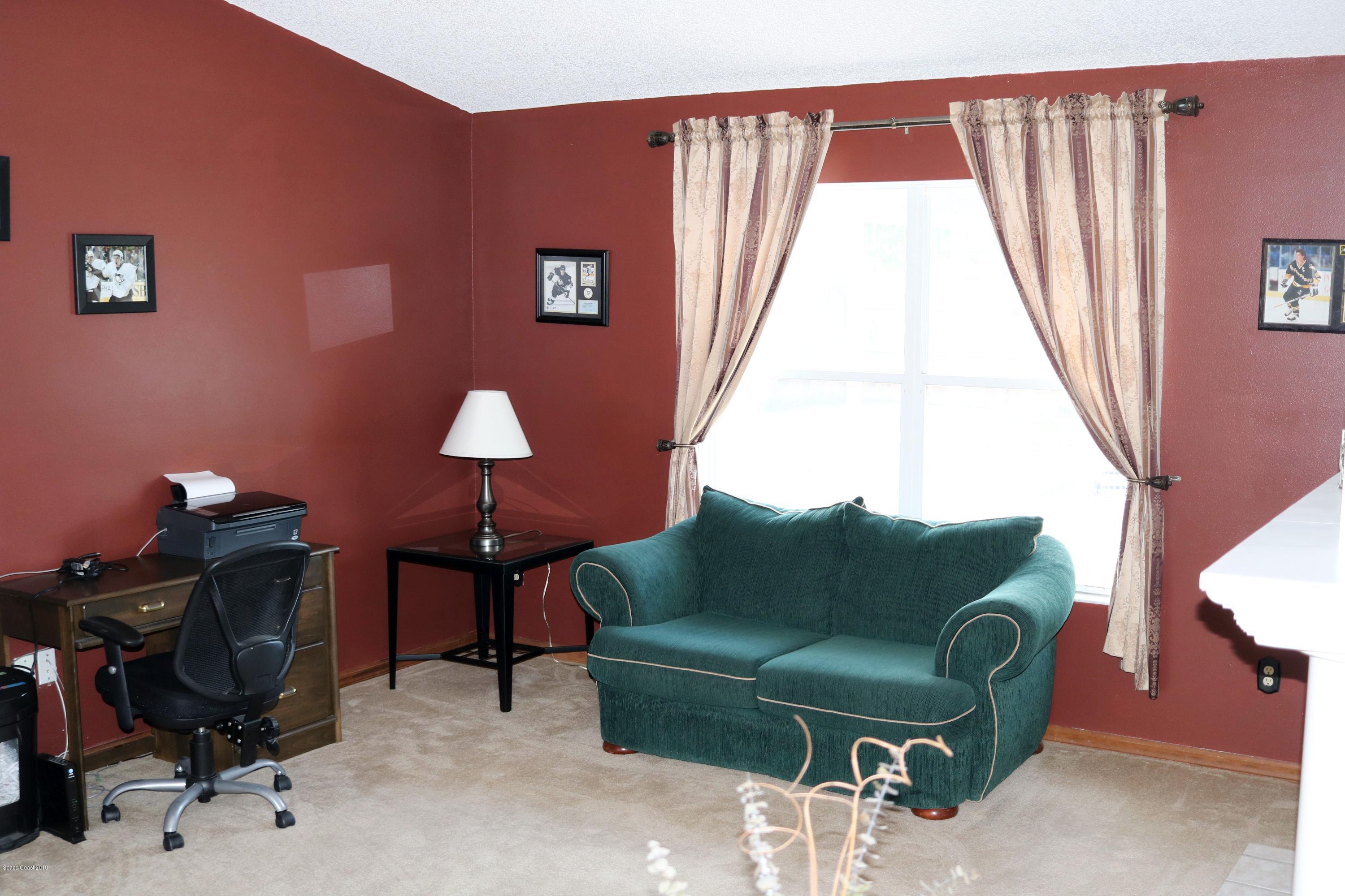 6154 Corning Road Cocoa, FL 32927 - Photo 7 of 16 a living room with furniture and a window
