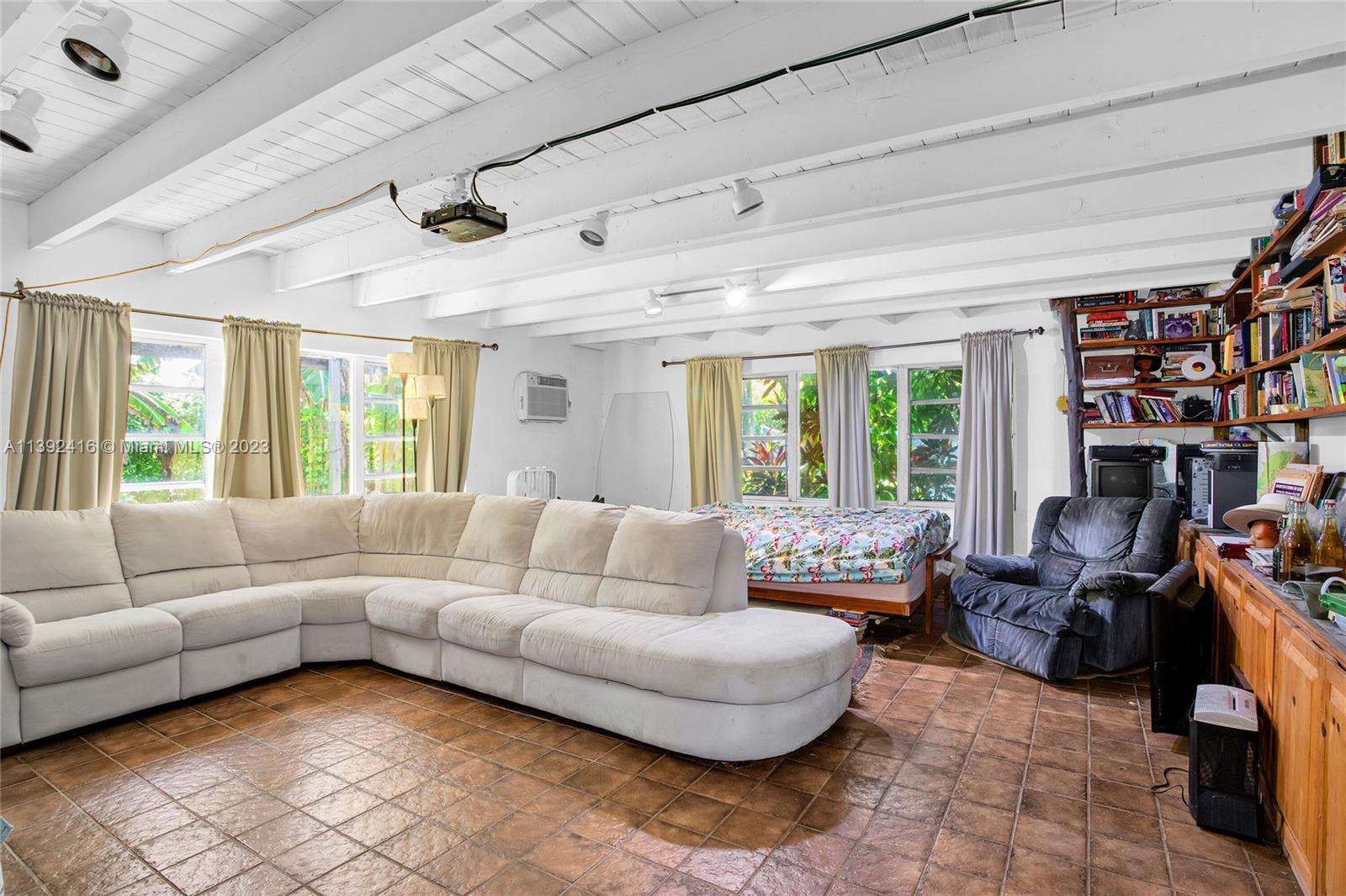 1541 Calais Drive Miami Beach, FL 33141 - Photo 16 of 33 a living room with furniture and a large window