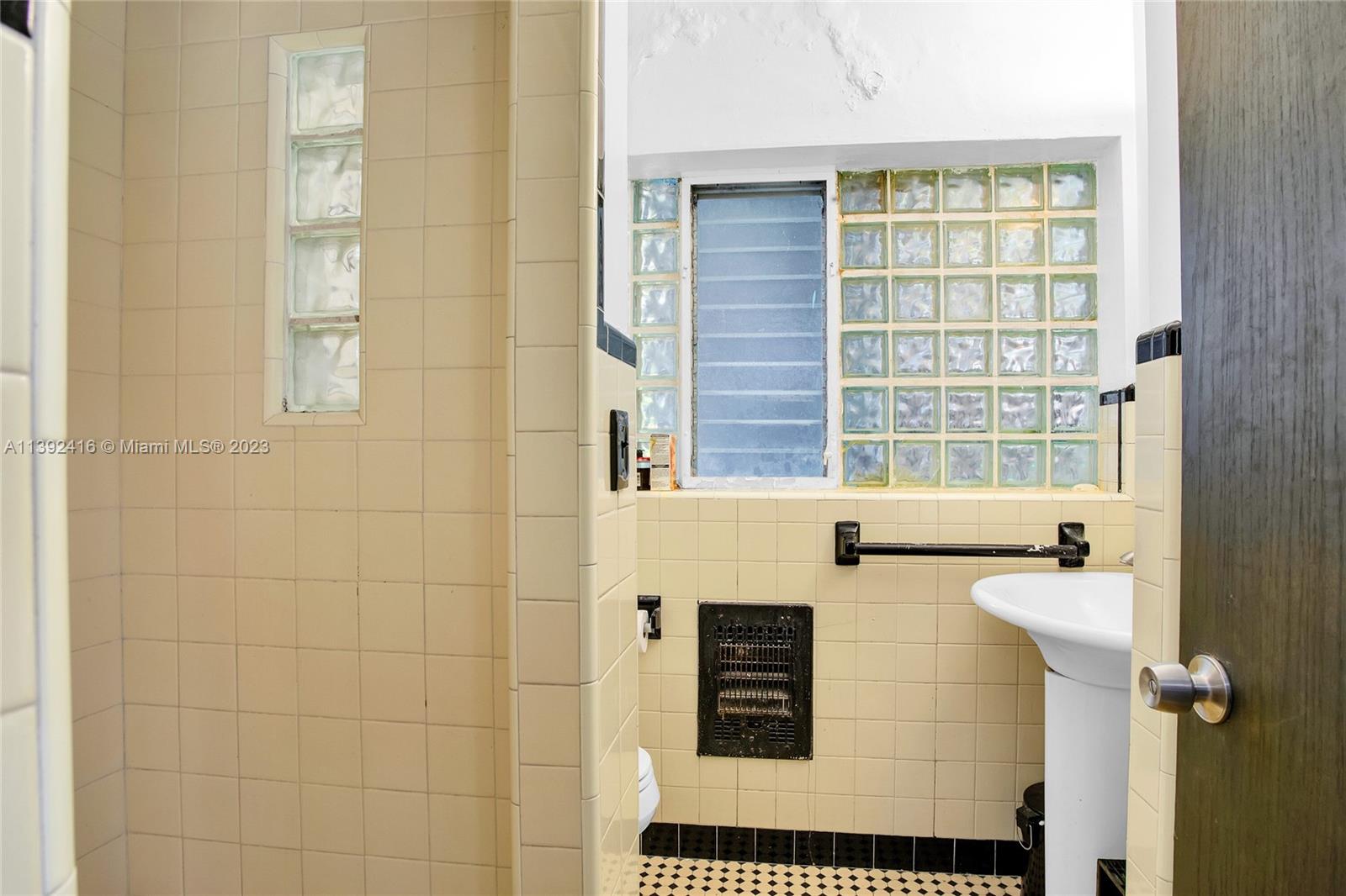 1541 Calais Drive Miami Beach, FL 33141 - Photo 19 of 33 a bathroom with a sink and a window