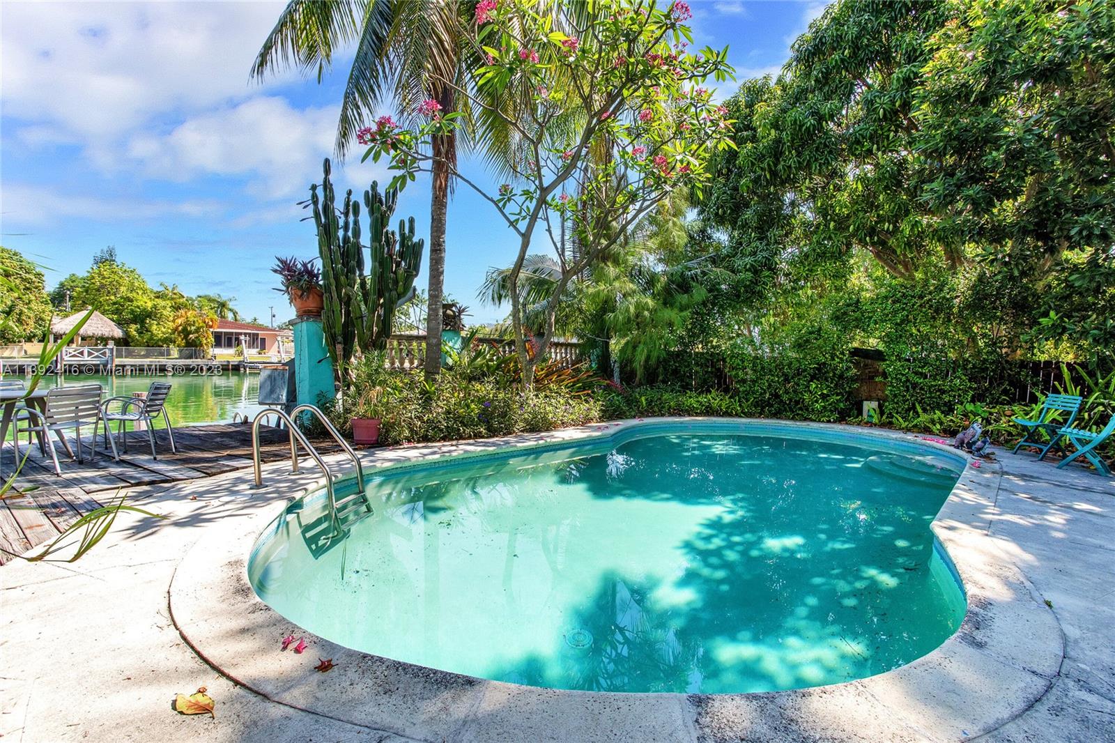 1541 Calais Drive Miami Beach, FL 33141 - Photo 20 of 33 a view of a swimming pool with a yard