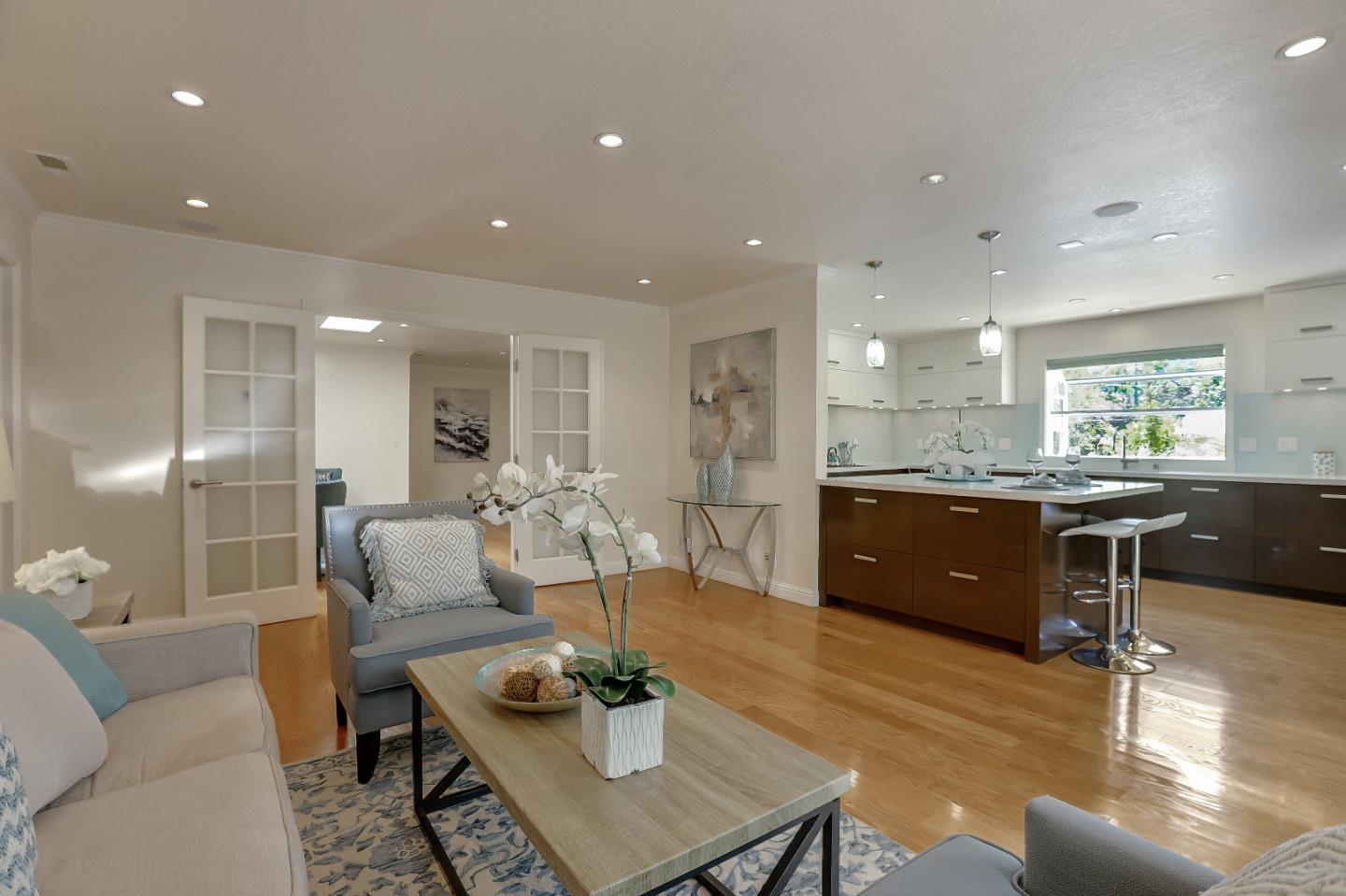 a living room with lots of furniture and kitchen view