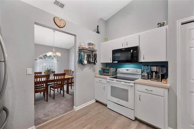 a view of kitchen with sink microwave and stove