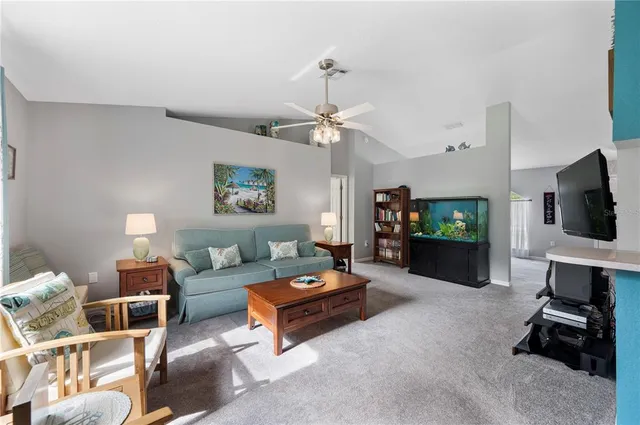 a living room with furniture a flat screen tv and a wall painting