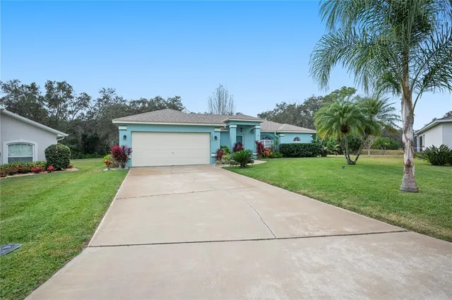 a front view of house with yard and green space