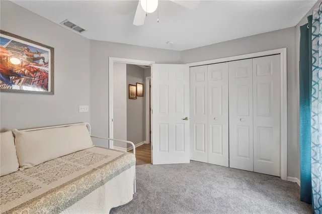 a bedroom with a bed and a painting on the wall