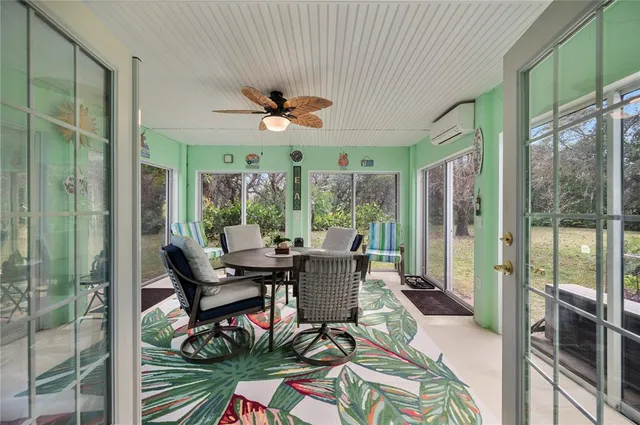 a dining room with furniture a chandelier and wooden floor