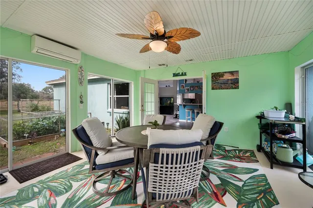 a dining room with furniture a rug and a large window