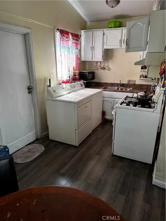 a kitchen with wooden cabinets and white appliances