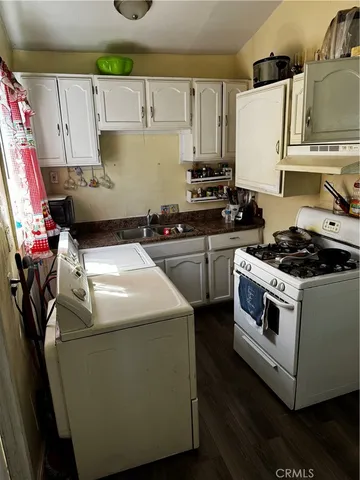 a kitchen with a stove a sink and a refrigerator