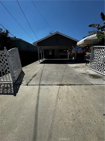 a black car parked in front of a house