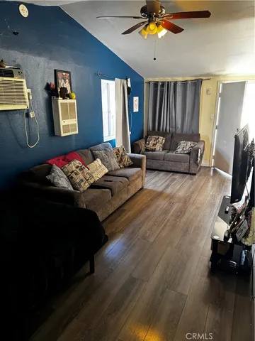 a spacious bedroom with a bed and a chandelier