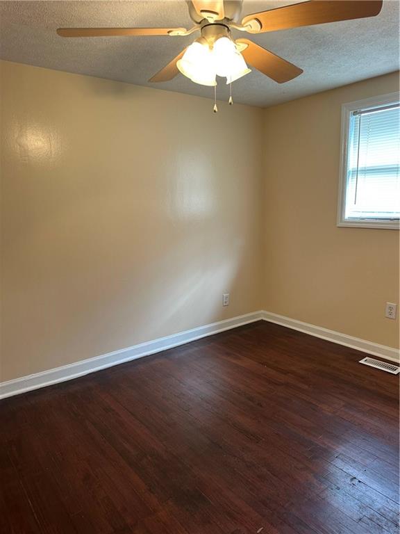 615 Cassville Road Southeast, Unit A Cartersville, GA 30120 - Photo 12 of 21 an empty room with wooden floor fan and window
